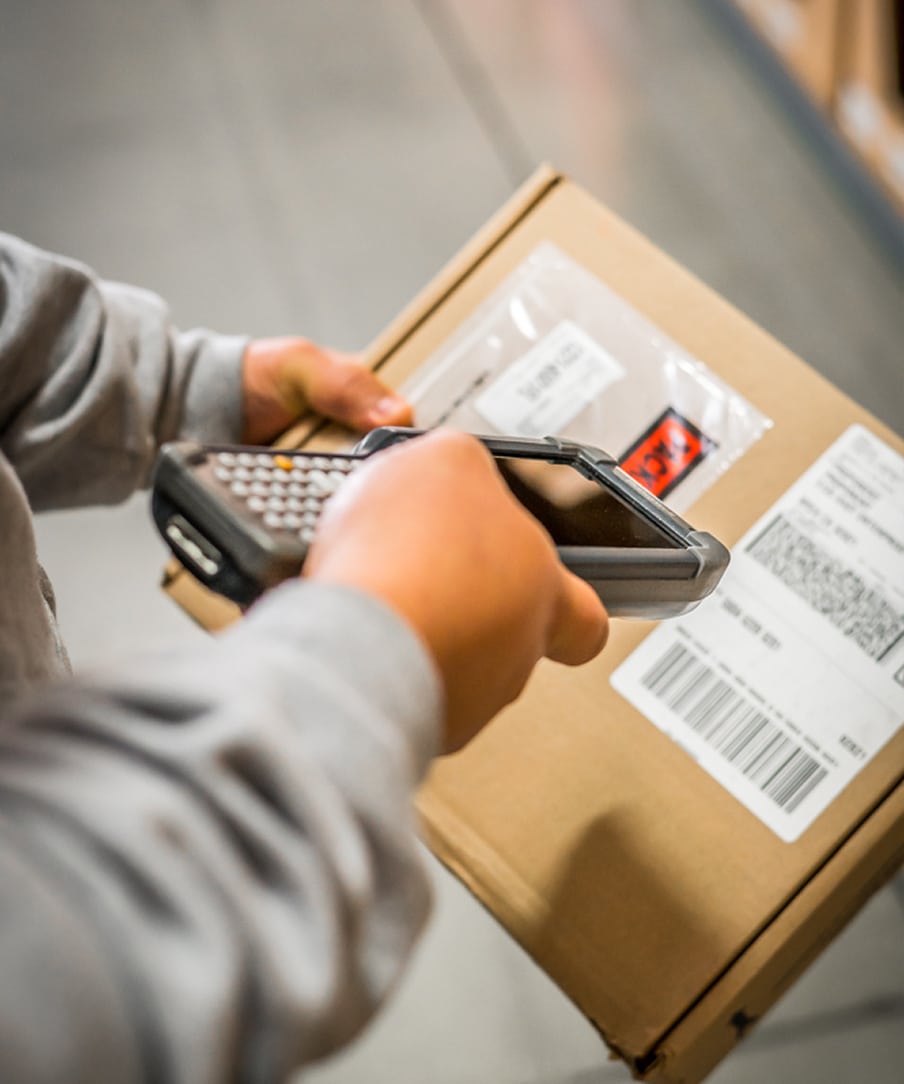 A person scanning a package
