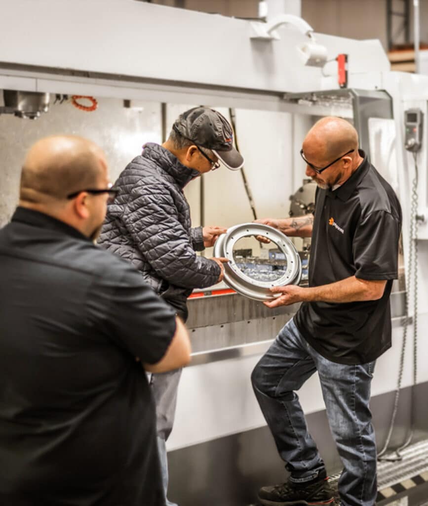 Proponent team members working alongside someone