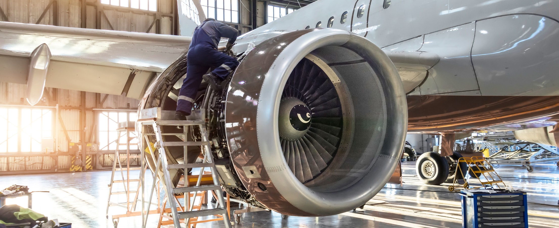 Person working on a jet engine