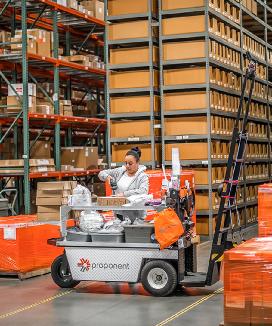 Employee scanning parts next to a forklift